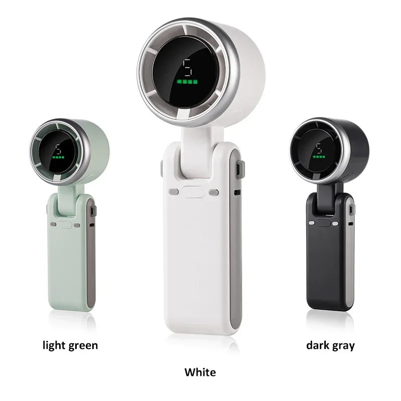 Three portable handheld bladeless fans in different colors—light green, white, and dark gray—are displayed upright against a white background. Each fan features a circular digital display at the top and a foldable handle. The display shows a fan speed indicator and battery level bars.