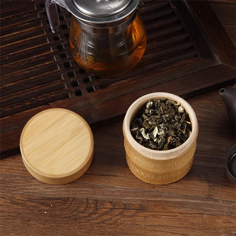 Wooden container with tea leaves and a lid on a wooden surface