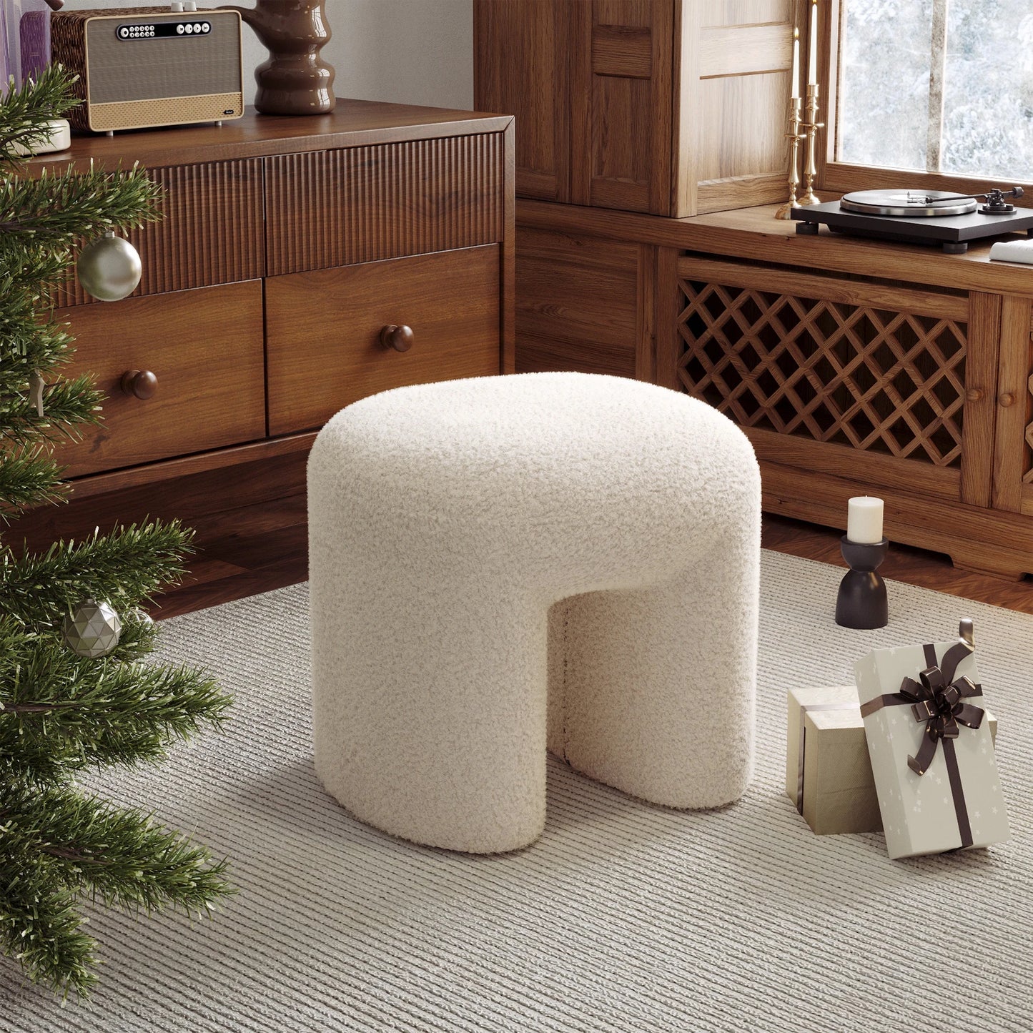 Beige ottoman in a room with wooden furniture and a Christmas tree.