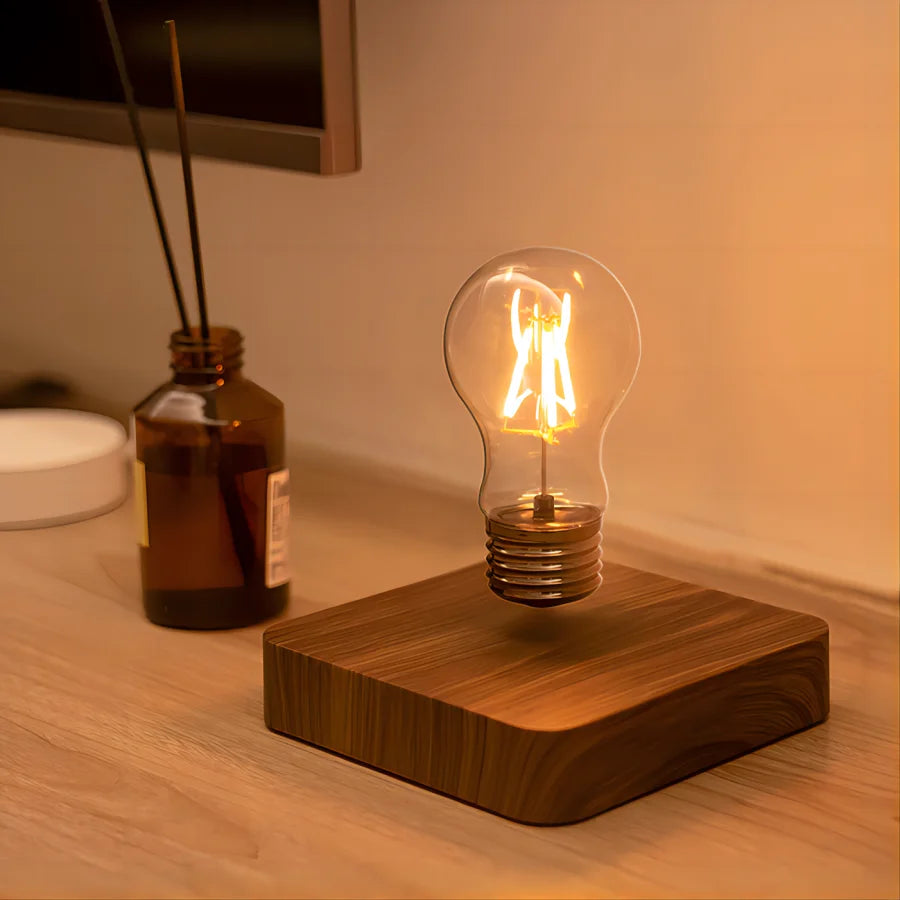 Light bulb on a wooden base on a wooden surface with a diffused background