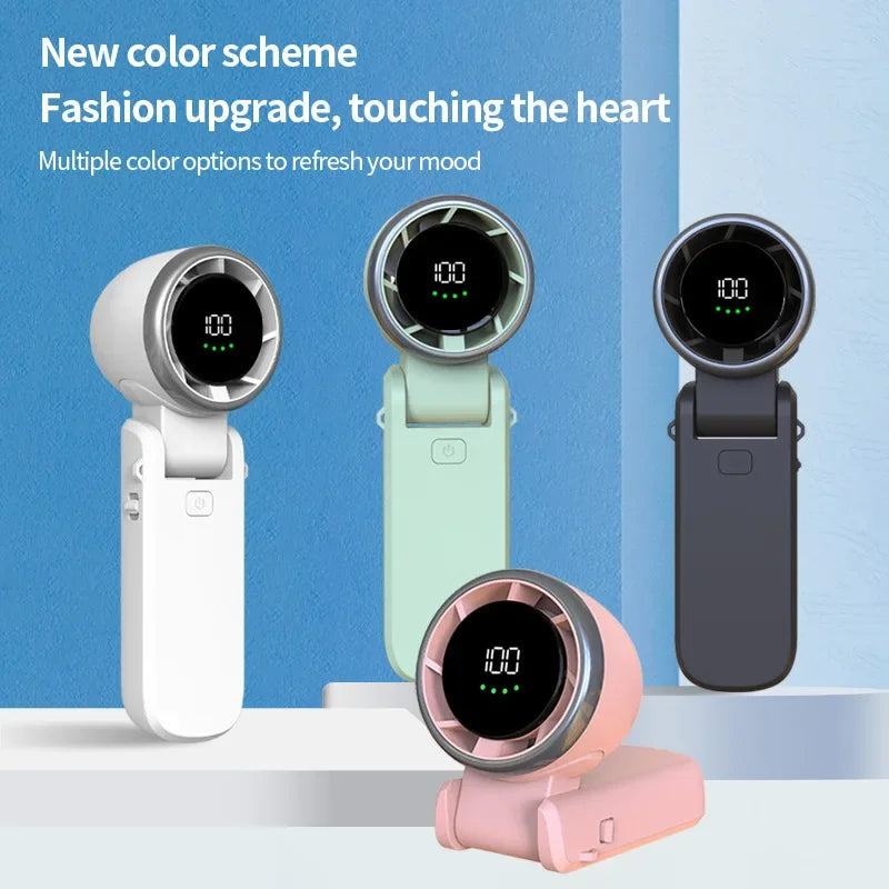 Four bladeless handheld fans are displayed in different colors—white, mint green, dark gray, and pink—against a blue and white background. Each fan has a digital screen showing "100" and green battery level bars. The pink fan is shown in a folded, angled position, highlighting its adjustable design. Text above reads: “New color scheme, Fashion upgrade, touching the heart. Multiple color options to refresh your mood.”