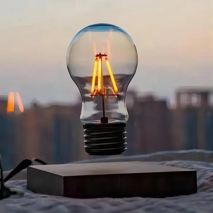 Levitating bulb with glowing filament against a blurred cityscape background