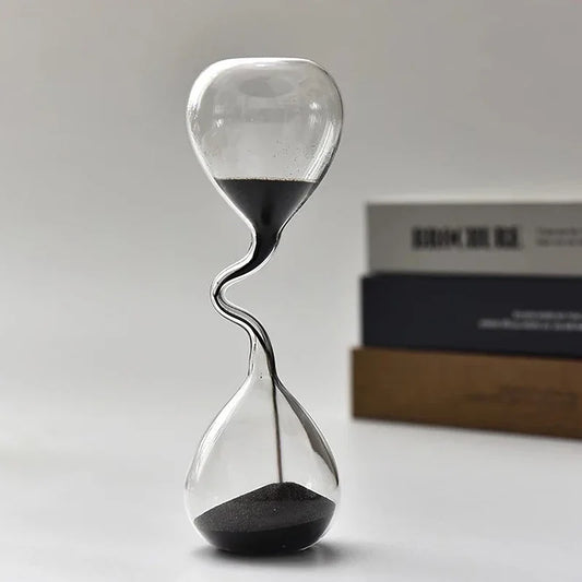  hourglass with sand running down on a neutral background